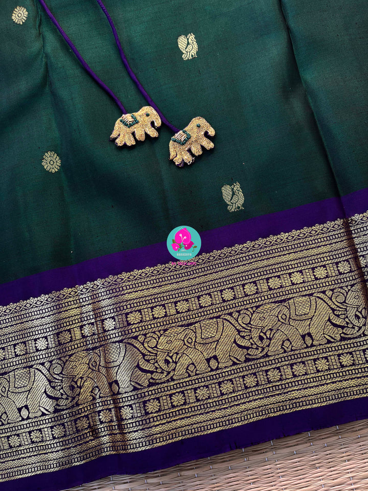 Vintage classic Kanchipattu saree in beautiful bottle green and purple Paired with hand embroidered blouse