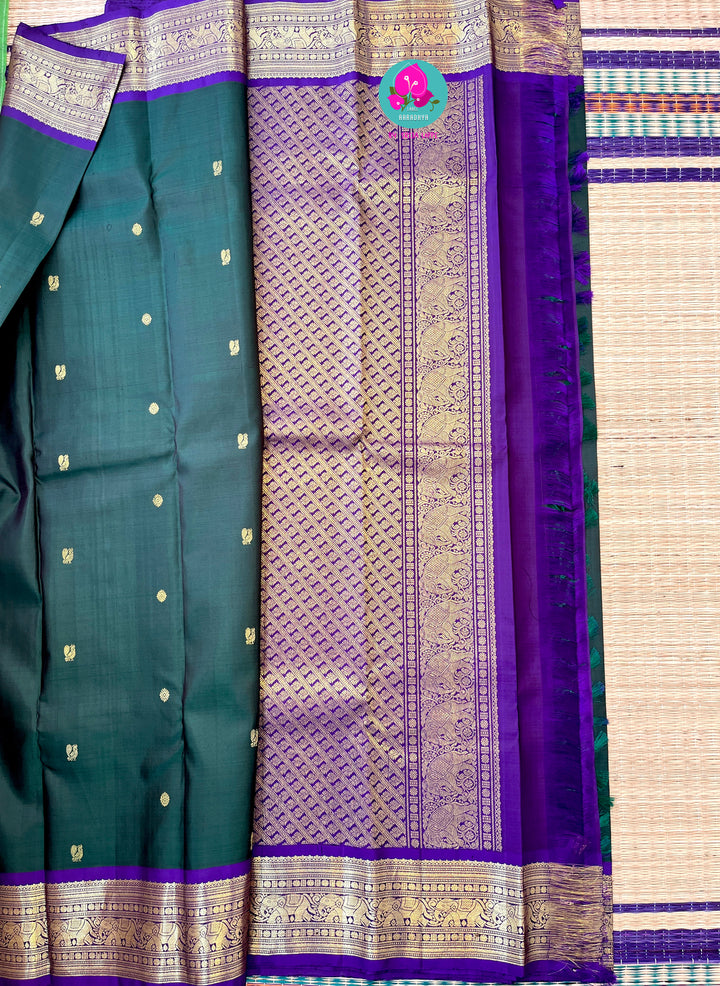 Vintage classic Kanchipattu saree in beautiful bottle green and purple Paired with hand embroidered blouse