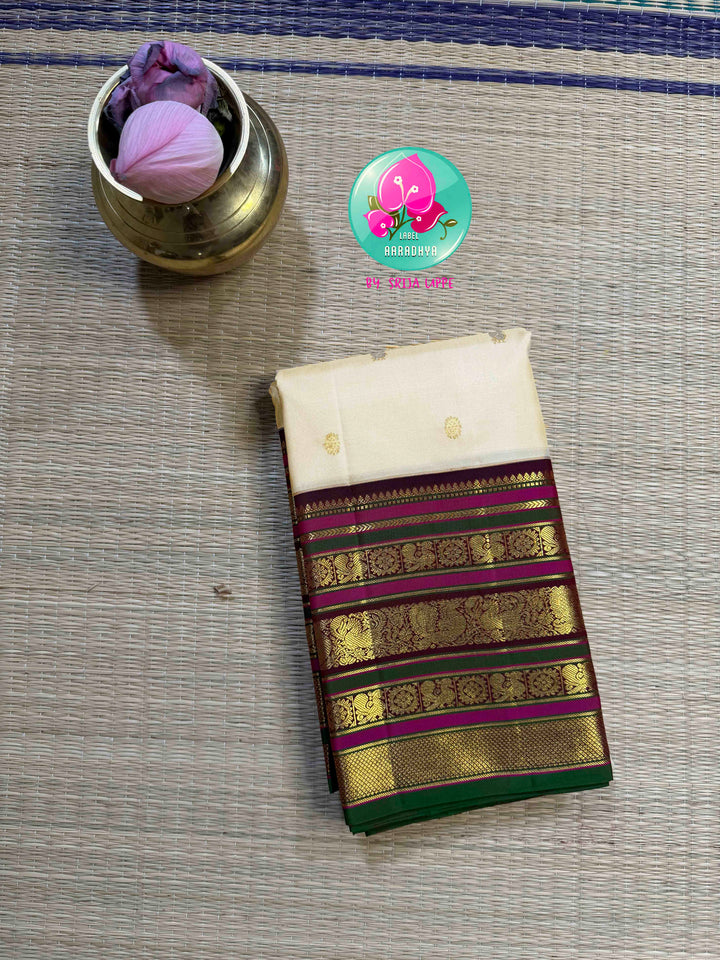 Ivory Grandeur: Off-white Kanchipattu with Zari-Kissed Pink, Maroon, and Green Border