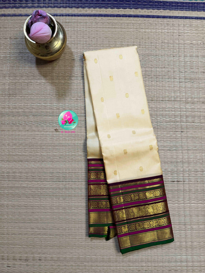 Ivory Grandeur: Off-white Kanchipattu with Zari-Kissed Pink, Maroon, and Green Border