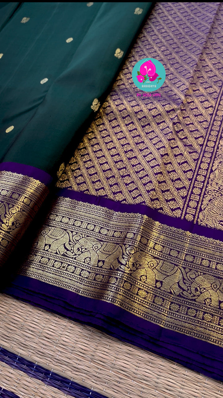 Vintage classic Kanchipattu saree in beautiful bottle green and purple Paired with hand embroidered blouse