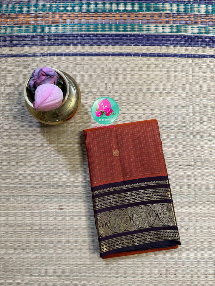 Autumn’s Anthem: Rust Orange Kanchipattu saree with the Majestic Elephant Border