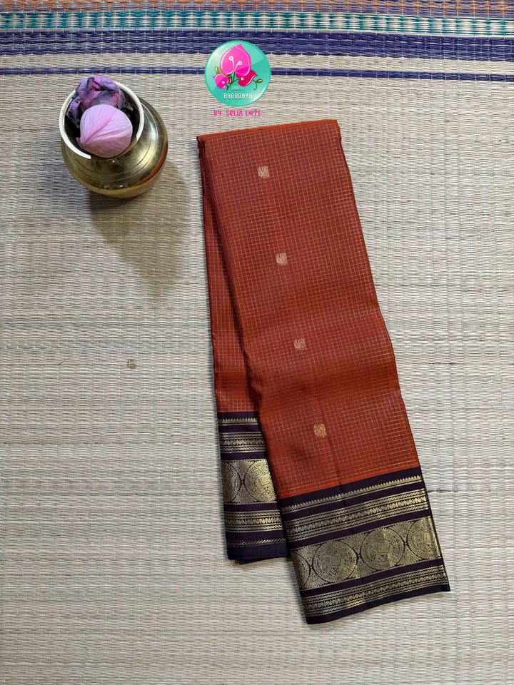 Autumn’s Anthem: Rust Orange Kanchipattu saree with the Majestic Elephant Border