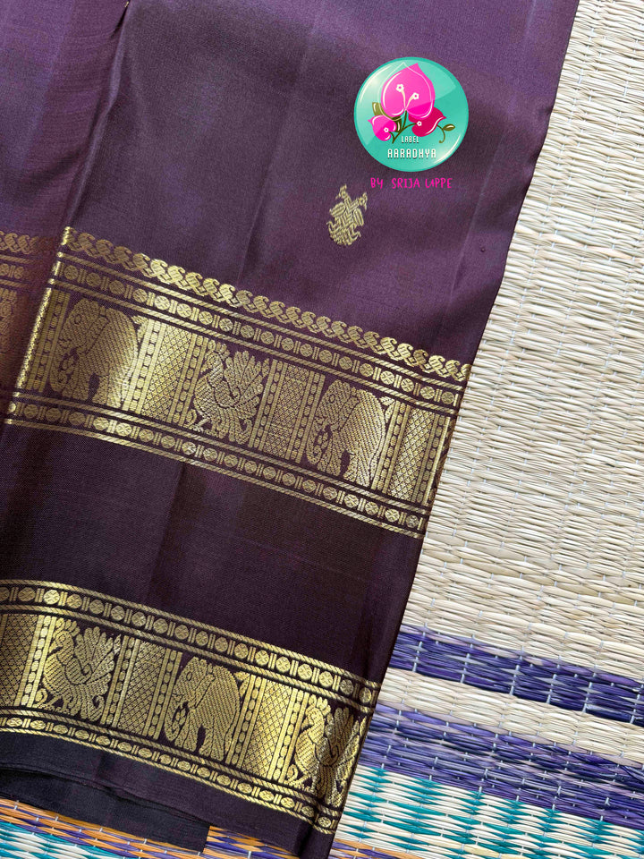 Trendy Brown Kanchipattu silk Saree with Commanding Gandaberunda Motifs