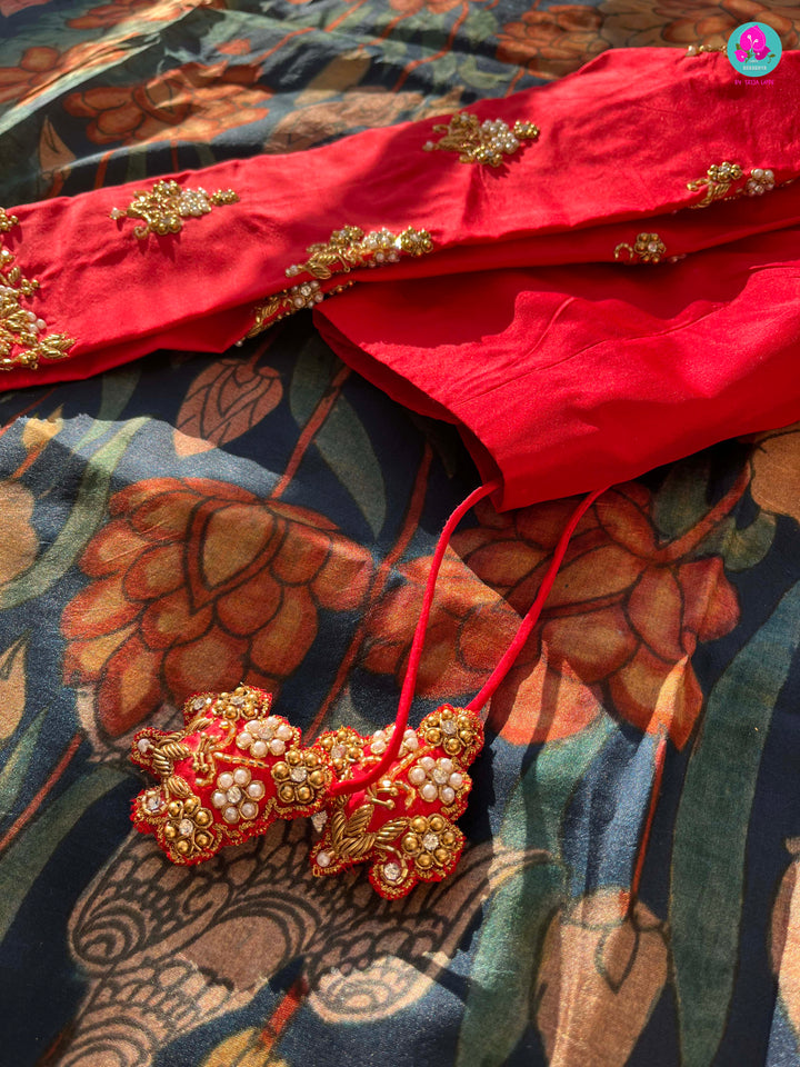 Blue kalamkari printed saree with red border paired with pure silk maggam work blouse