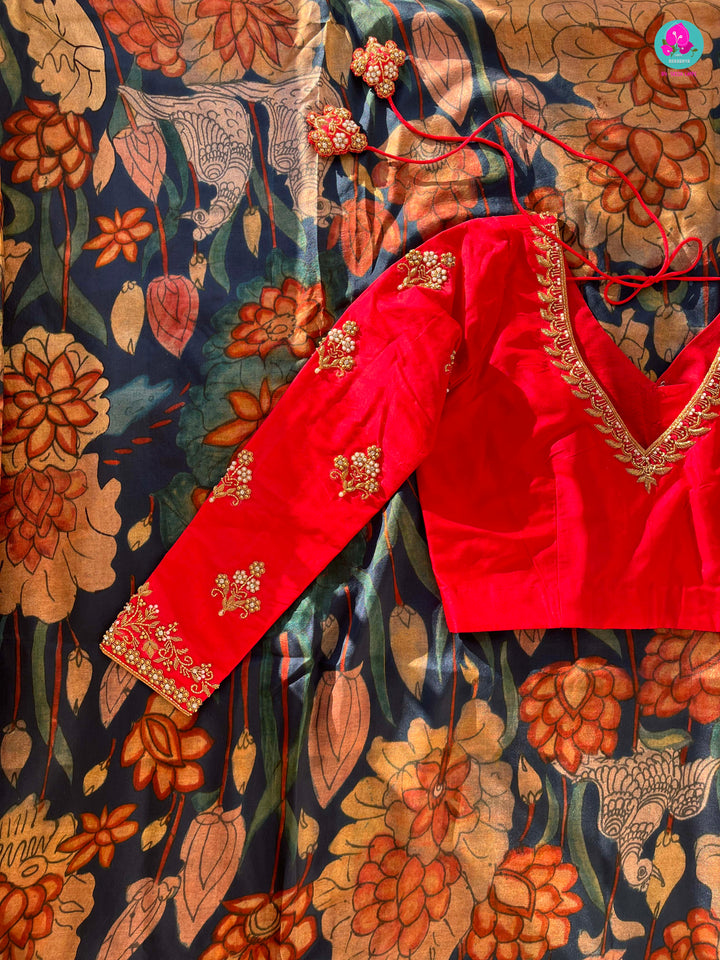 Blue kalamkari printed saree with red border paired with pure silk maggam work blouse
