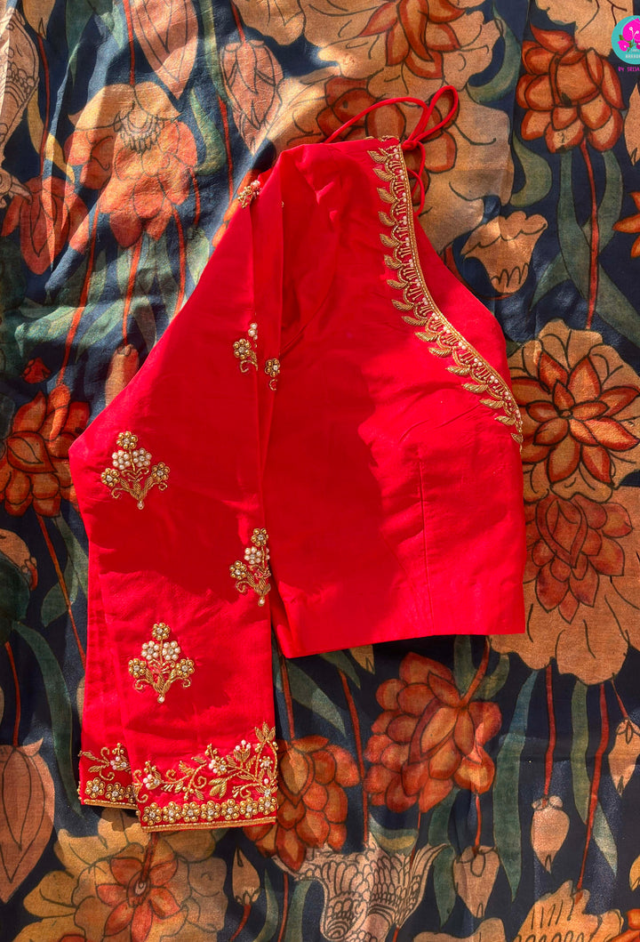 Blue kalamkari printed saree with red border paired with pure silk maggam work blouse