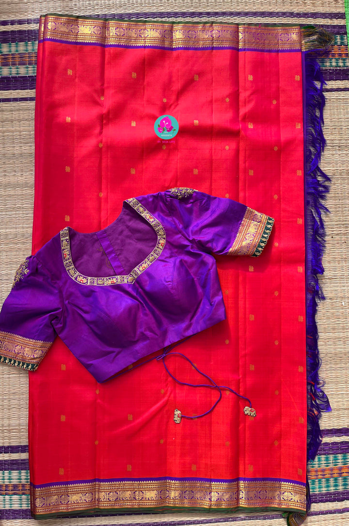 Pinkish shade of red with deep purple border Kanchipuram silk Saree paired with hand embroidered blouse