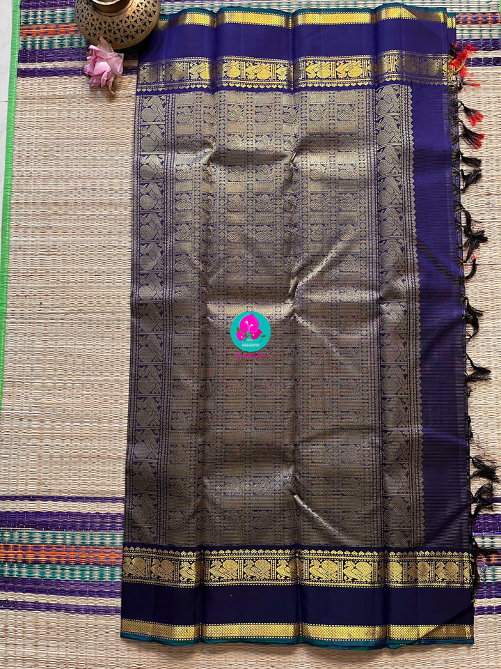 2g zari Vaira Oosi check butta in beautiful shade of blue with gap border