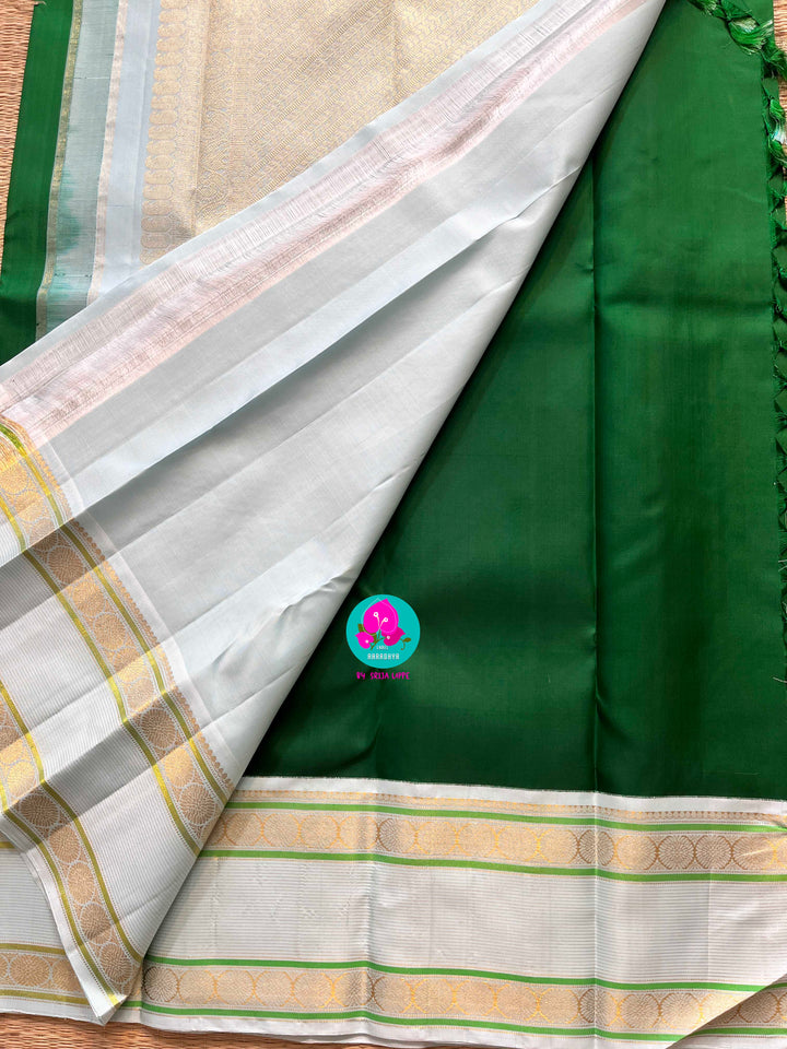 Bottle green vintage saree with ice blue border is one of a kind