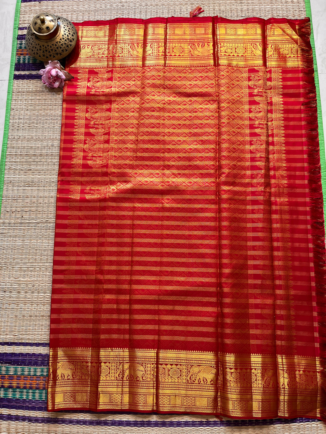 Red Kanchipattu saree in traditional motifs with borders