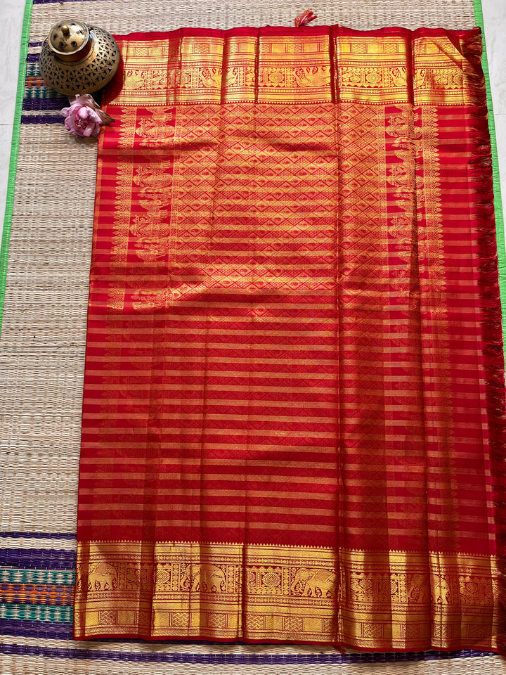 Red Kanchipattu saree in traditional motifs with borders
