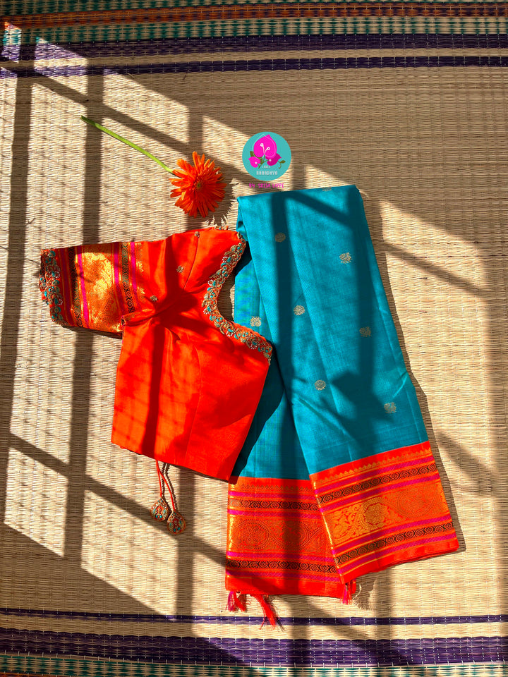 Starlit Symphony: Regal Dark Blue Kanjivaram Saree Paired with a Sunrise Orange Artisan Blouse