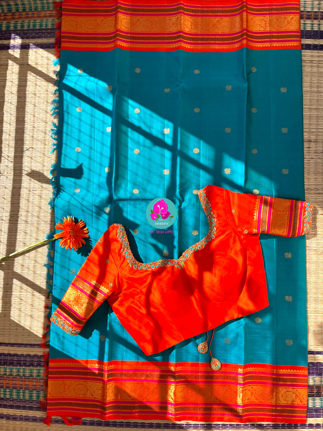 Starlit Symphony: Regal Dark Blue Kanjivaram Saree Paired with a Sunrise Orange Artisan Blouse