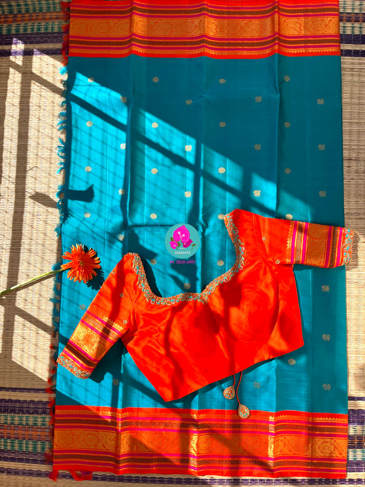 Starlit Symphony: Regal Dark Blue Kanjivaram Saree Paired with a Sunrise Orange Artisan Blouse