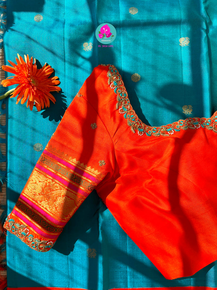Starlit Symphony: Regal Dark Blue Kanjivaram Saree Paired with a Sunrise Orange Artisan Blouse