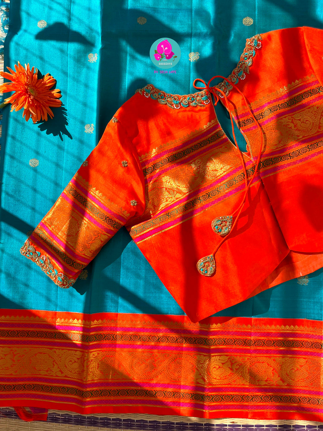 Starlit Symphony: Regal Dark Blue Kanjivaram Saree Paired with a Sunrise Orange Artisan Blouse