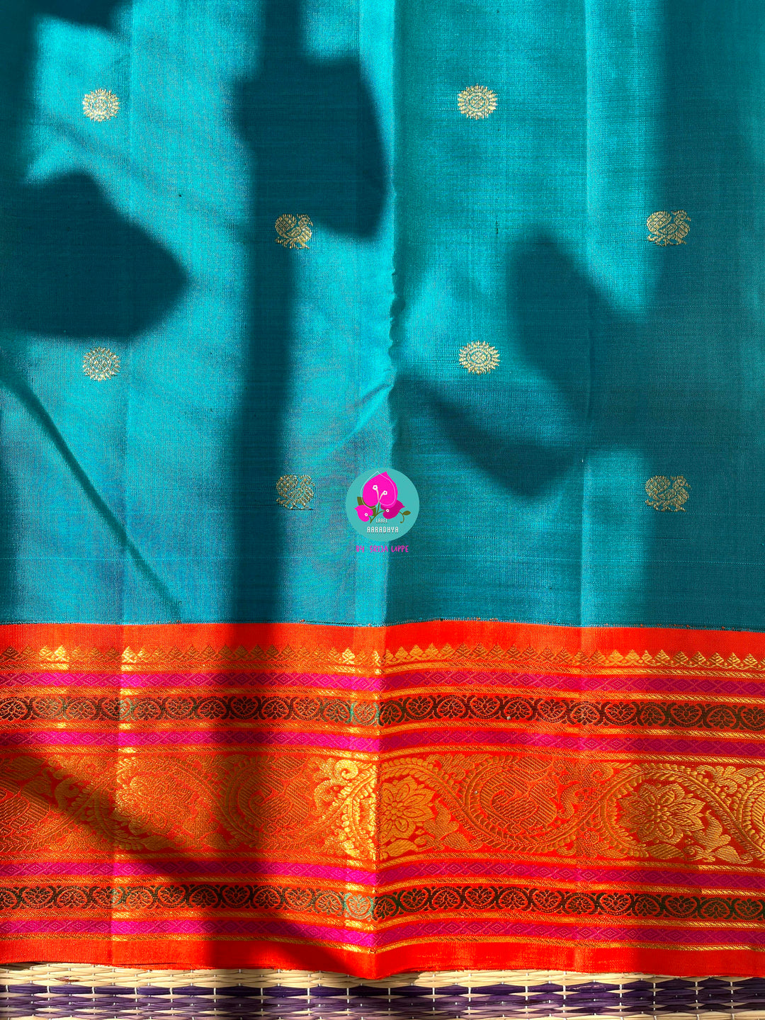 Starlit Symphony: Regal Dark Blue Kanjivaram Saree Paired with a Sunrise Orange Artisan Blouse