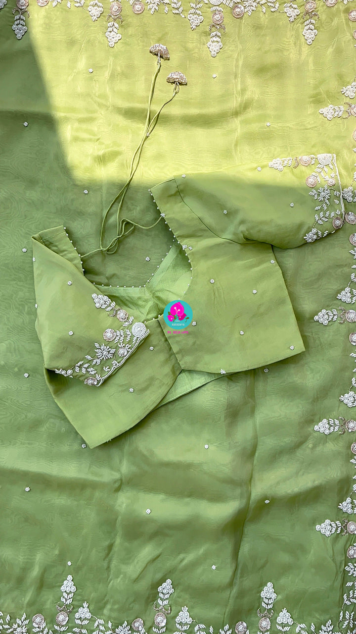 Satin crape saree with hand embroidered pearl work paired with Hand Embroidered Blouse