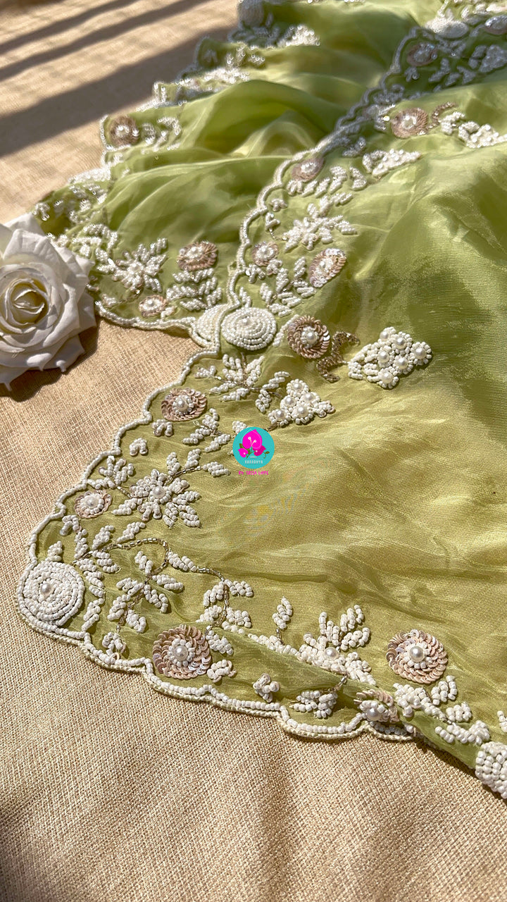 Satin crape saree with hand embroidered pearl work paired with Hand Embroidered Blouse
