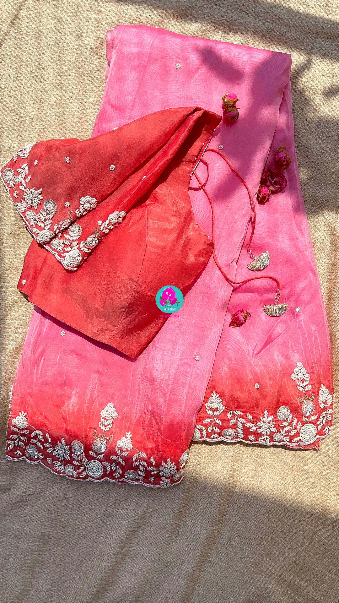 Dual shaded pink and peach saree in satin crape with hand embroidered pearl work paired with Hand Embroidered Blouse