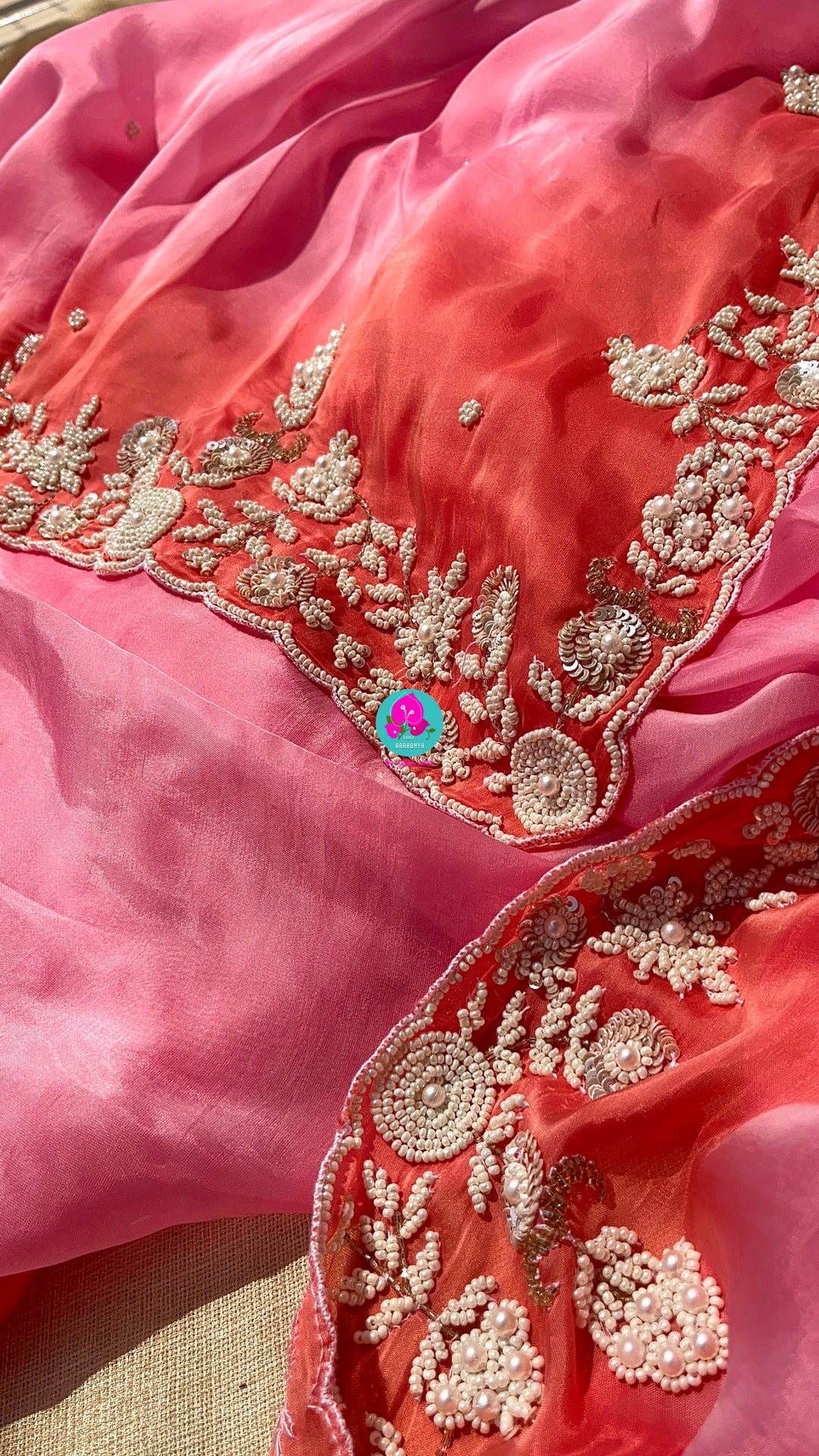 Dual shaded pink and peach saree in satin crape with hand embroidered pearl work paired with Hand Embroidered Blouse