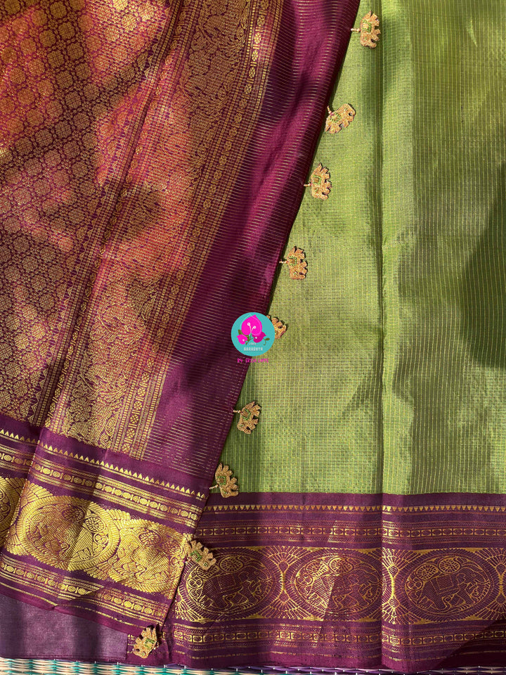 Nature’s Royalty: Olive Green Vaira Oosi Silk Saree with Deep Plum Border & Elephant Tassels