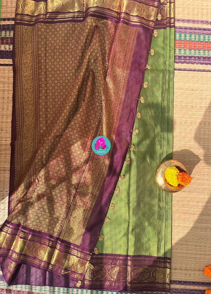 Nature’s Royalty: Olive Green Vaira Oosi Silk Saree with Deep Plum Border & Elephant Tassels