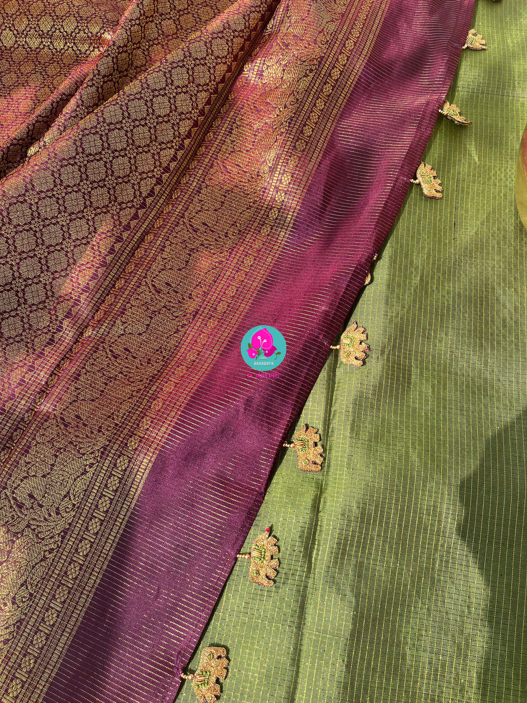 Nature’s Royalty: Olive Green Vaira Oosi Silk Saree with Deep Plum Border & Elephant Tassels