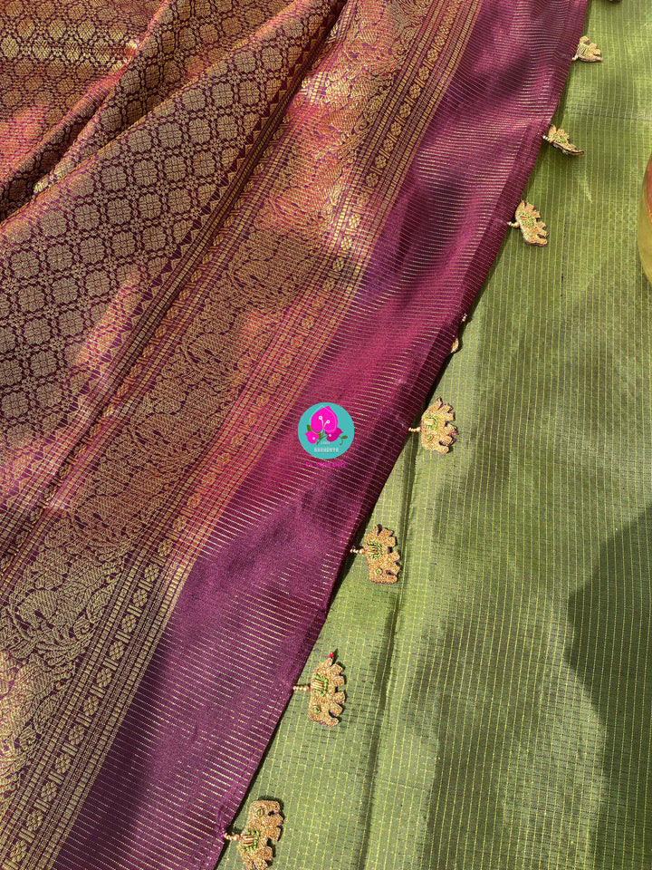 Nature’s Royalty: Olive Green Vaira Oosi Silk Saree with Deep Plum Border & Elephant Tassels
