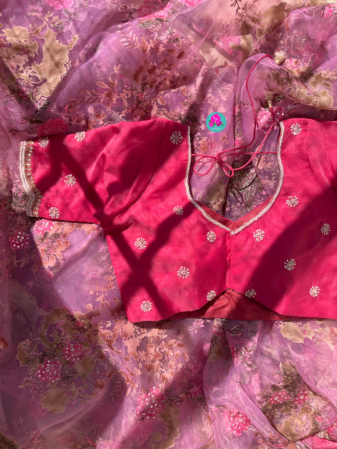 Brasso organza saree with hand embroidery paired with hand embroidered stitched blouse