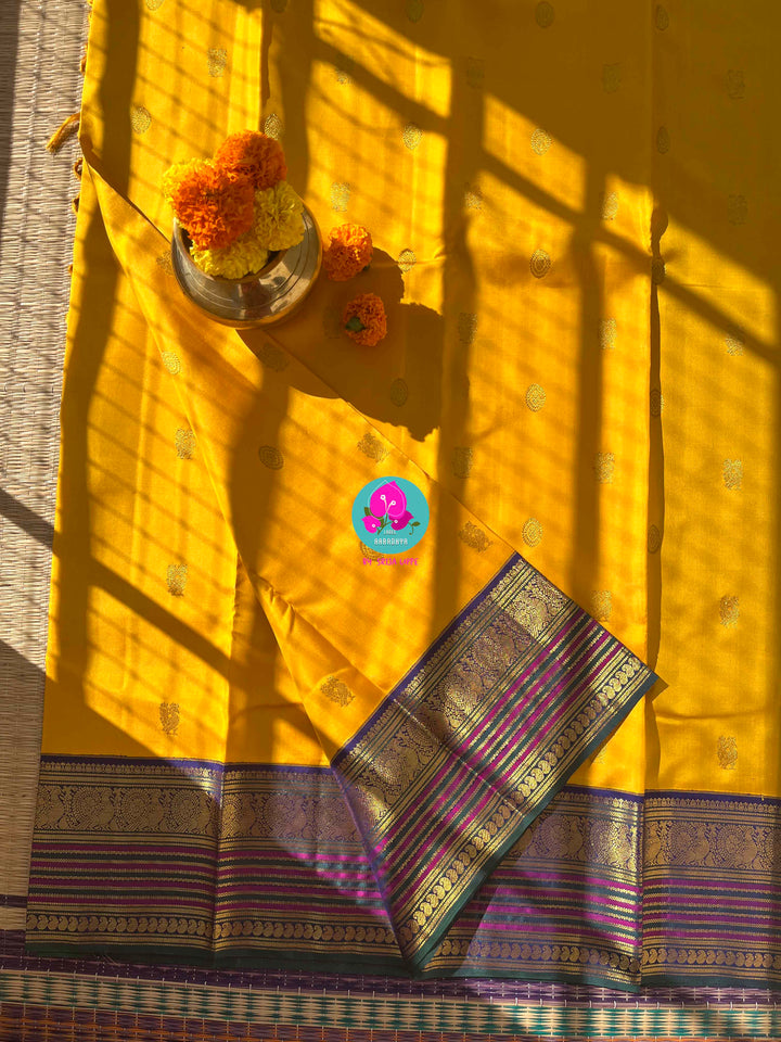 Suvarna Ganneru Splendor: Vintage Yellow Kanchipattu Saree with Artisan Blue Blouse
