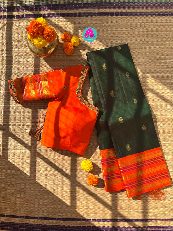 Regal Dark bottle Green Kanjivaram Saree Paired with a Sunrise Orange Artisan Blouse