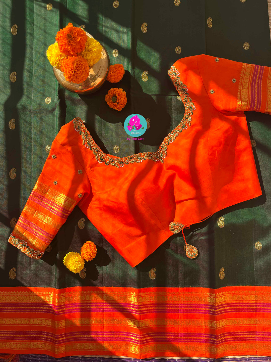 Regal Dark bottle Green Kanjivaram Saree Paired with a Sunrise Orange Artisan Blouse