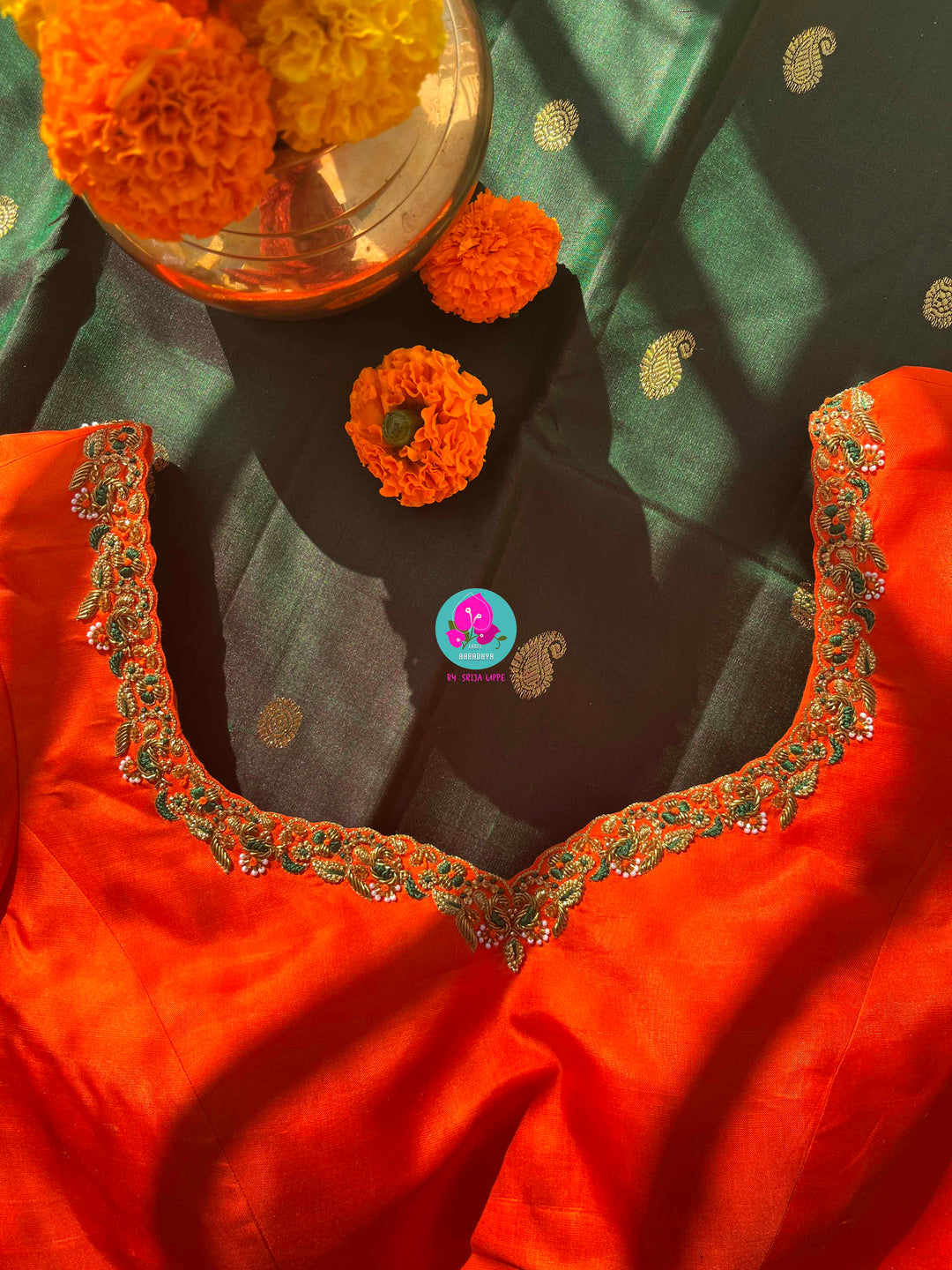 Regal Dark bottle Green Kanjivaram Saree Paired with a Sunrise Orange Artisan Blouse