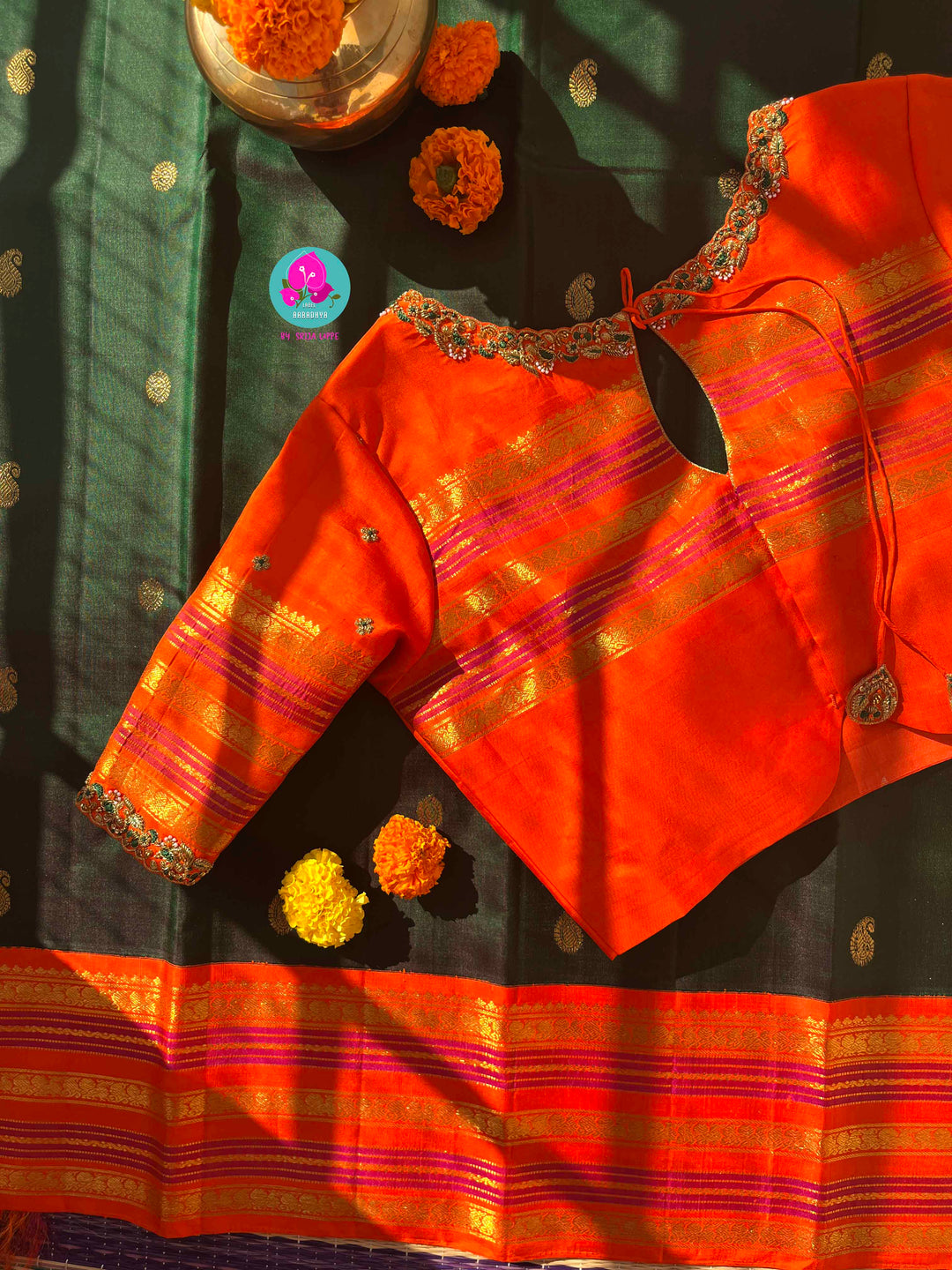 Regal Dark bottle Green Kanjivaram Saree Paired with a Sunrise Orange Artisan Blouse