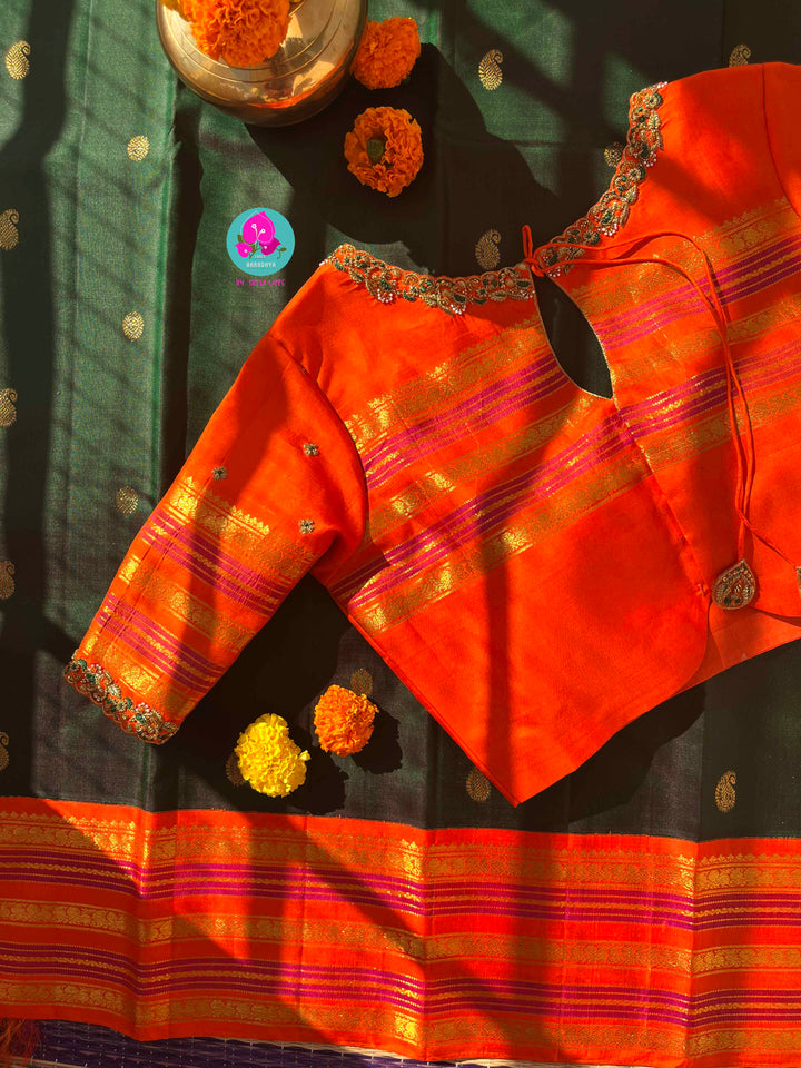 Regal Dark bottle Green Kanjivaram Saree Paired with a Sunrise Orange Artisan Blouse