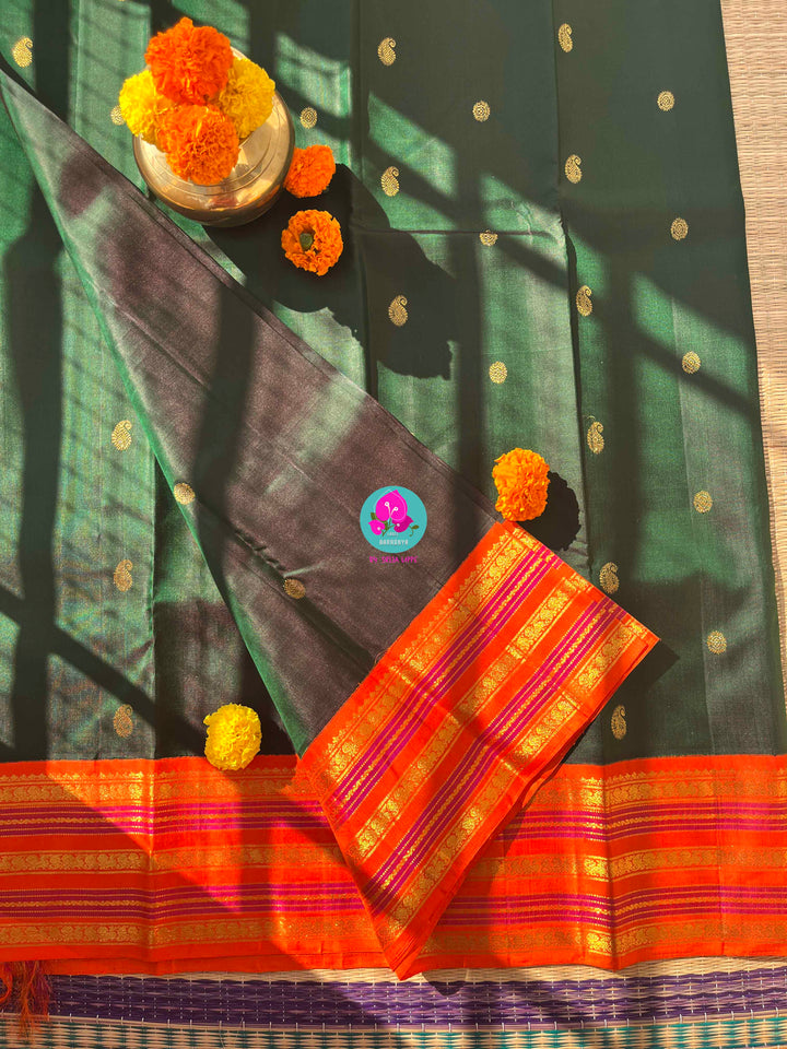 Regal Dark bottle Green Kanjivaram Saree Paired with a Sunrise Orange Artisan Blouse