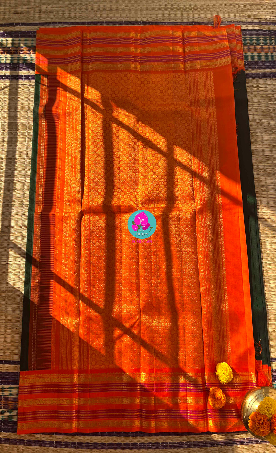 Regal Dark bottle Green Kanjivaram Saree Paired with a Sunrise Orange Artisan Blouse