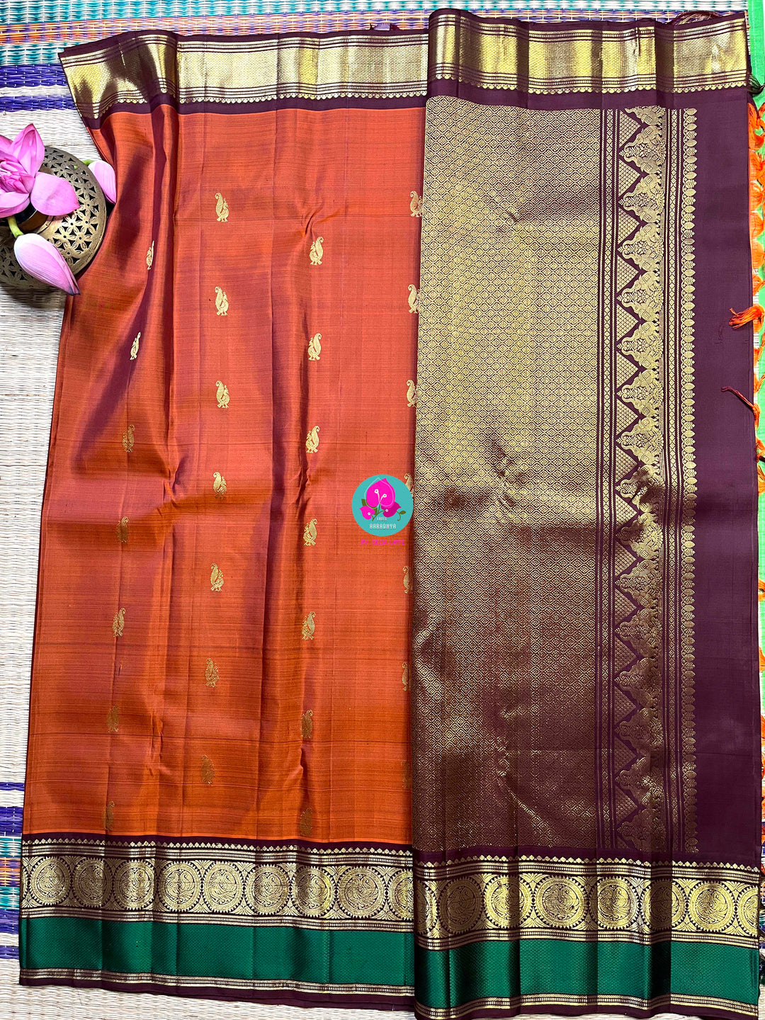 Kanchipattu handloom saree warm rust orange by a contrast border in sophisticated brown and a touch of vibrant green