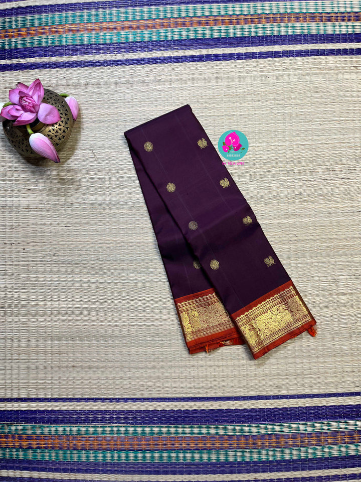 Pure Kanchipattu saree in traditional brown and orange is the classiest and elegant saree