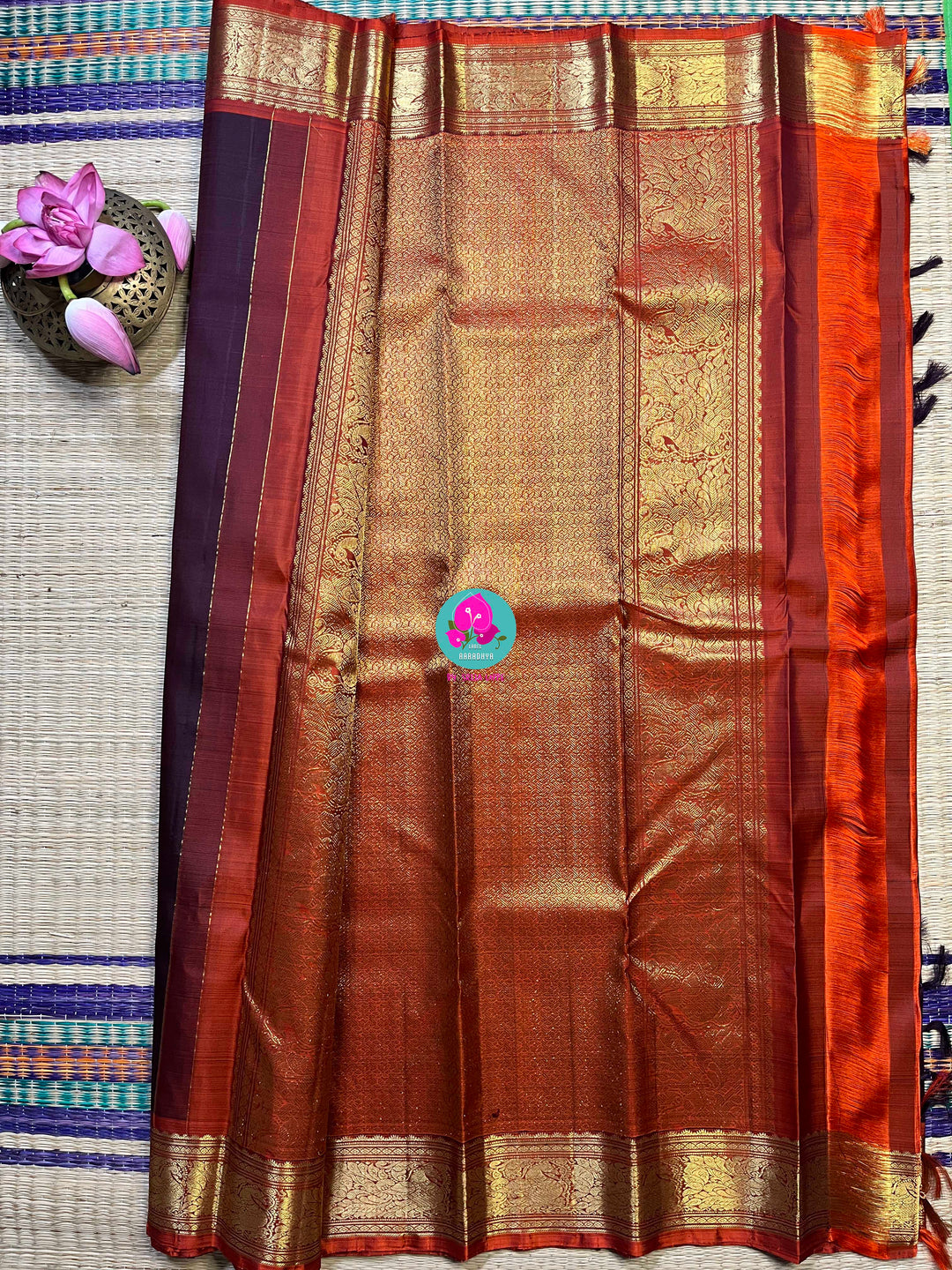 Pure Kanchipattu saree in traditional brown and orange is the classiest and elegant saree