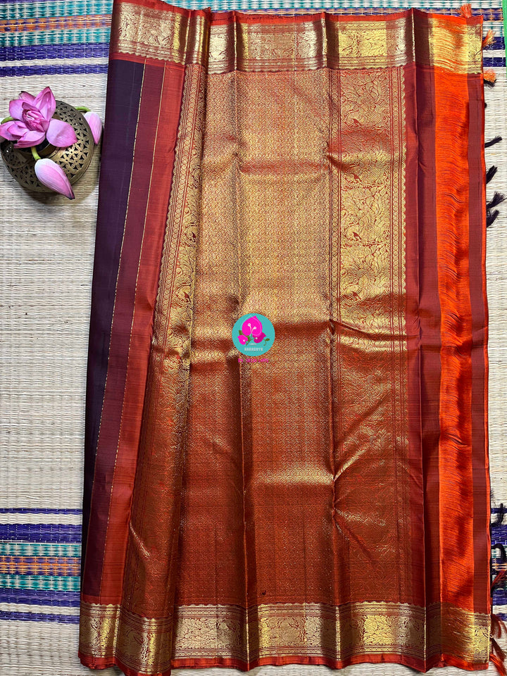 Pure Kanchipattu saree in traditional brown and orange is the classiest and elegant saree