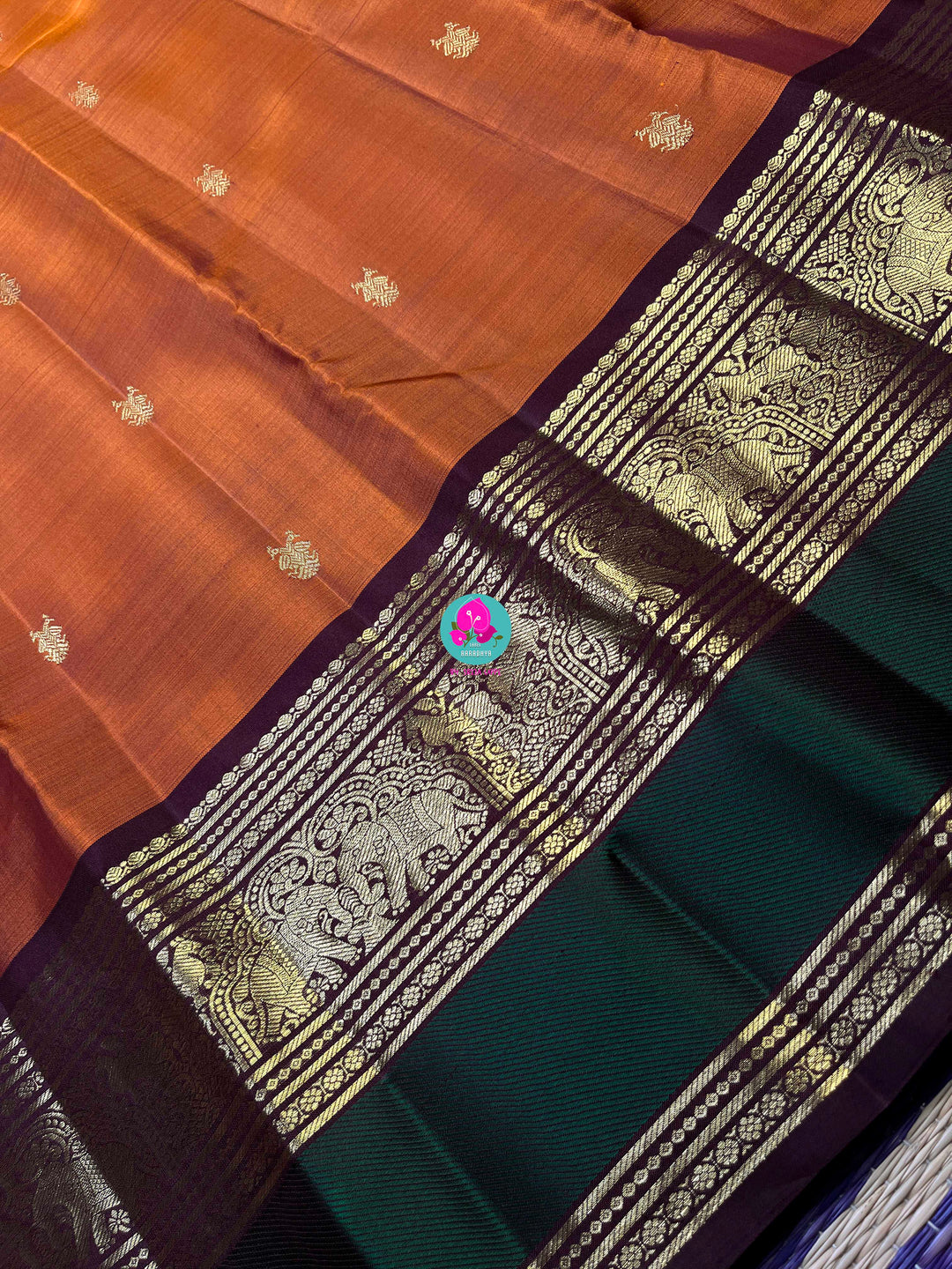 Kanchipattu handloom saree warm rust orange by a contrast border in sophisticated brown and a touch of vibrant green