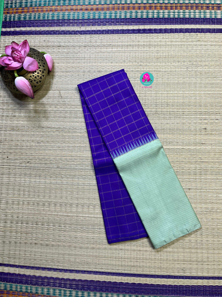 Royal blue checkered saree with a touch of pastel pista color