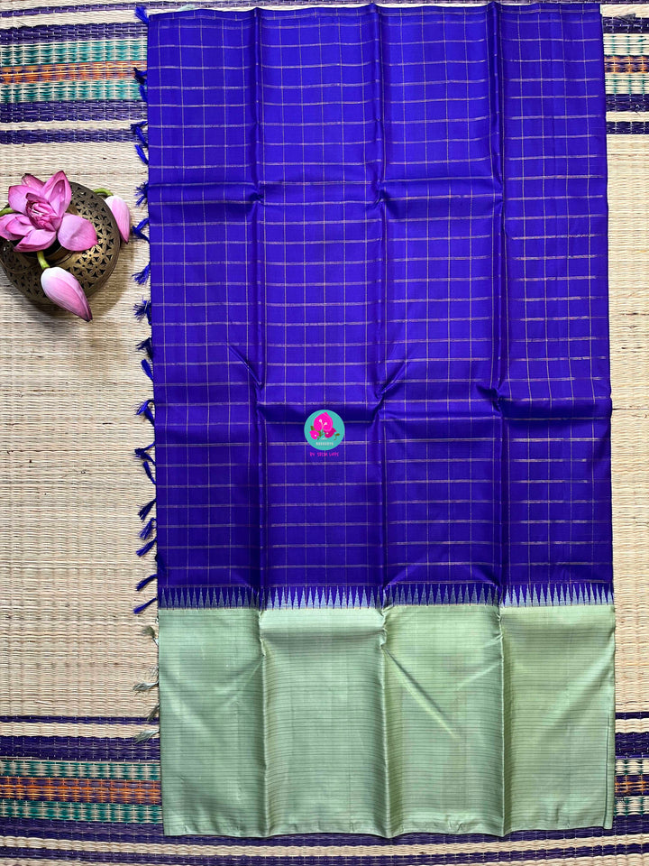 Royal blue checkered saree with a touch of pastel pista color
