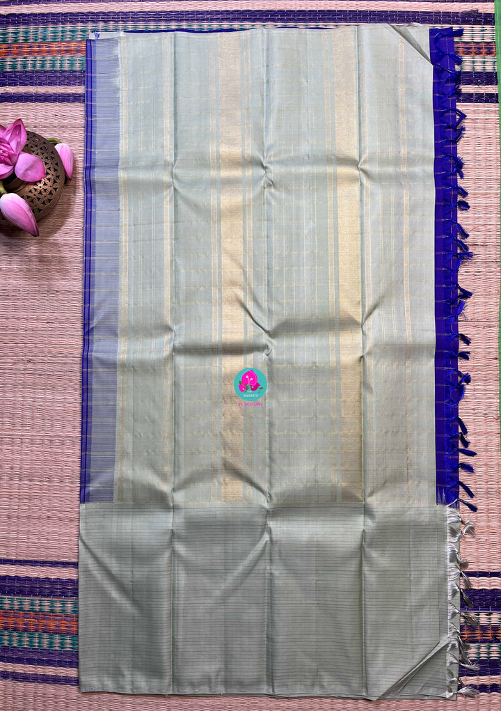 Royal blue checkered saree with a touch of pastel pista color