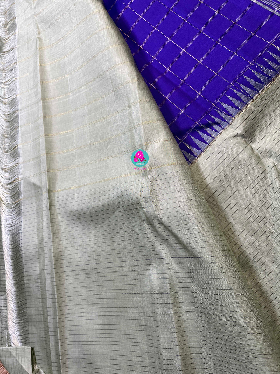 Royal blue checkered saree with a touch of pastel pista color