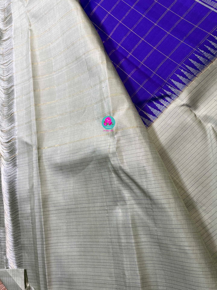 Royal blue checkered saree with a touch of pastel pista color