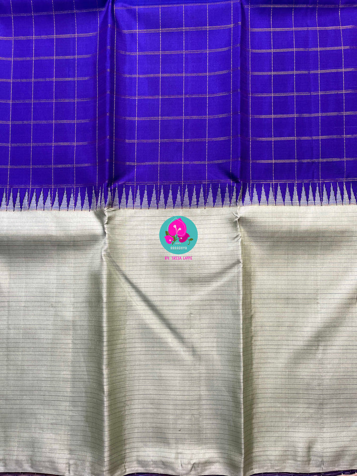 Royal blue checkered saree with a touch of pastel pista color